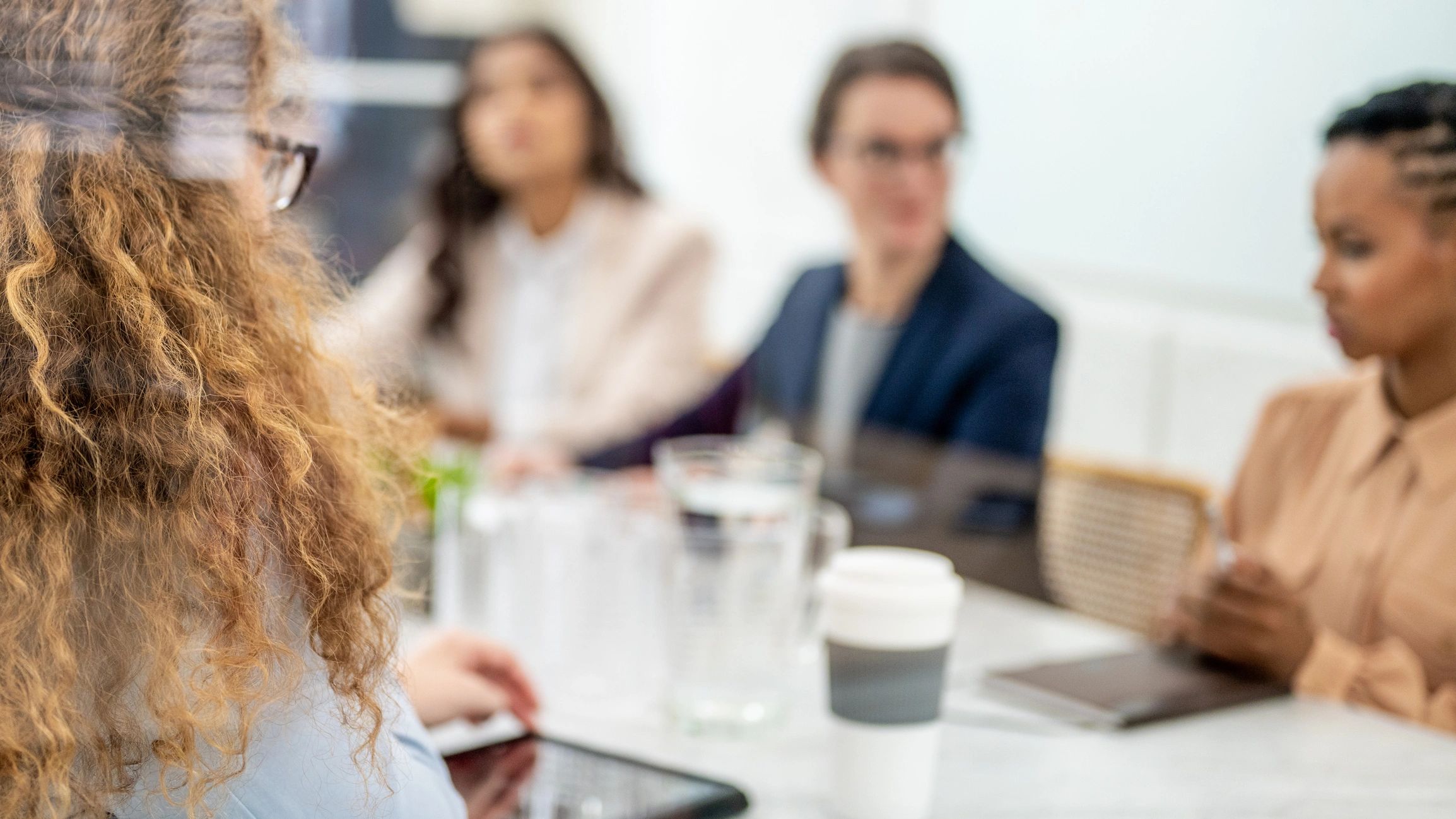 Two professionals discussing documents in a meeting